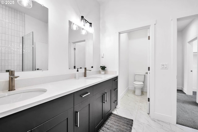 bathroom with tiled shower, vanity, and toilet