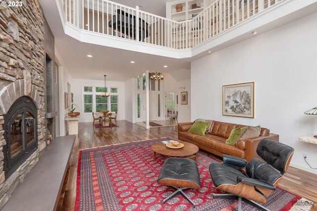 46769 Goodpasture Rd, Vida, OR 97488 - living area featuring a towering ceiling, a stone fireplace, baseboards, recessed lighting, and wood finished floors