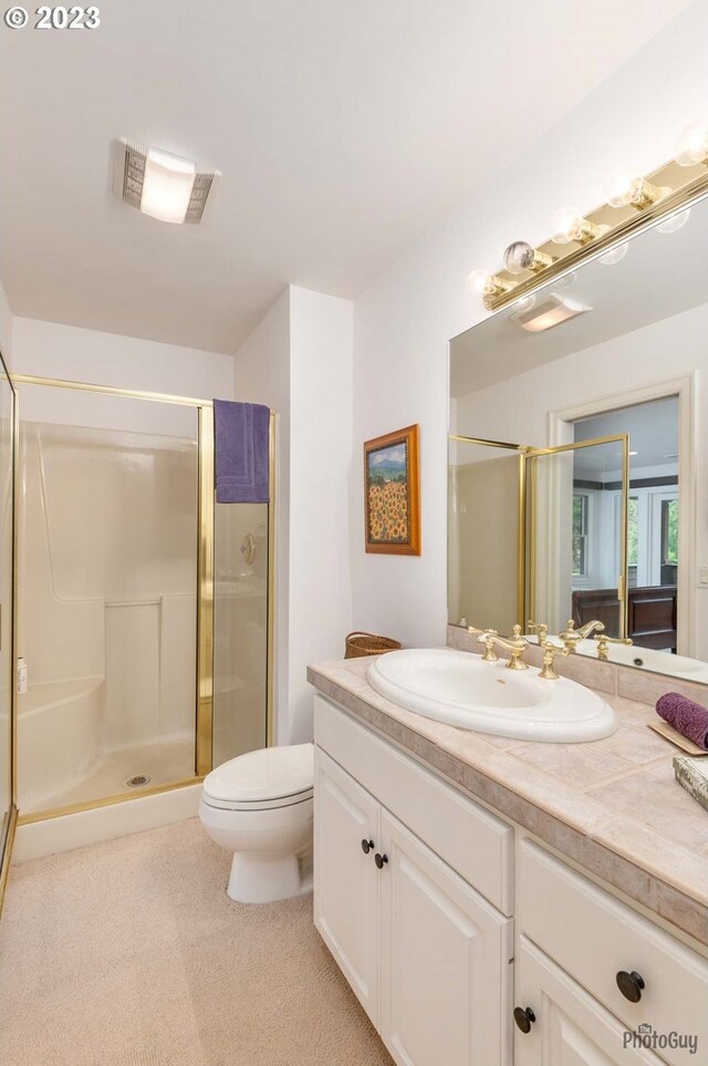 46769 Goodpasture Rd, Vida, OR 97488 - full bathroom featuring a shower stall, vanity, visible vents, and toilet