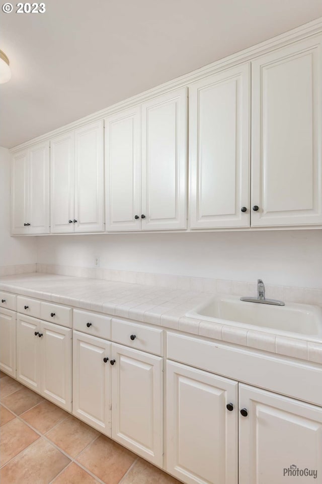 46769 Goodpasture Rd, Vida, OR 97488 - clothes washing area with light tile patterned floors and a sink