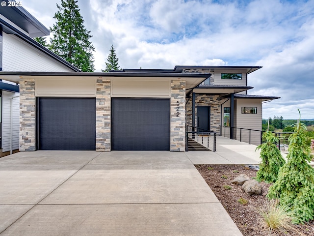 522 NE Province Dr, Camas, WA 98607 - view of front of property with concrete driveway, a garage, and stone siding