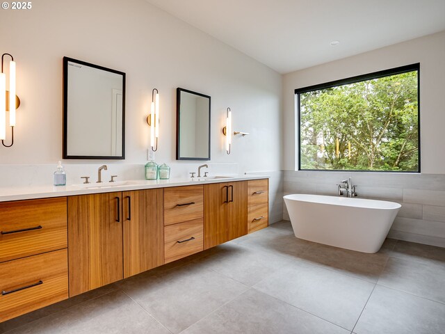 522 NE Province Dr, Camas, WA 98607 - bathroom with double vanity, tile walls, tile patterned floors, and a freestanding bath