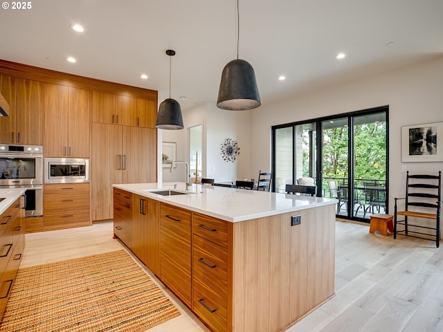 522 NE Province Dr, Camas, WA 98607 - kitchen featuring a sink, stainless steel appliances, light countertops, light wood finished floors, and recessed lighting