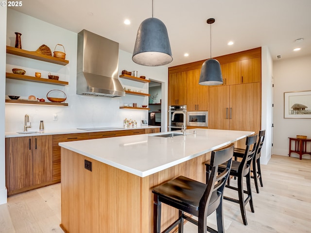 522 NE Province Dr, Camas, WA 98607 - kitchen featuring wall chimney range hood, open shelves, appliances with stainless steel finishes, a sink, and light countertops
