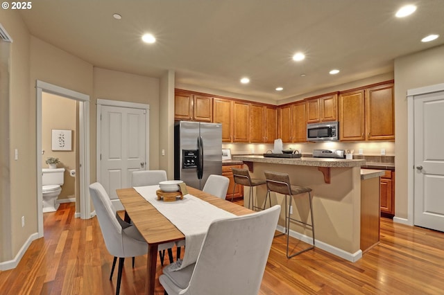 dining space with light hardwood / wood-style flooring