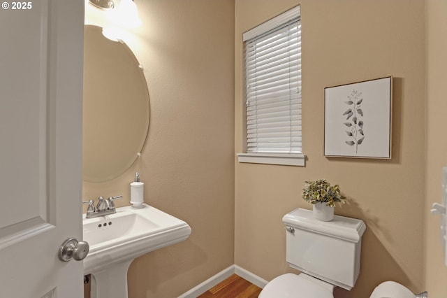 bathroom featuring sink, hardwood / wood-style floors, and toilet