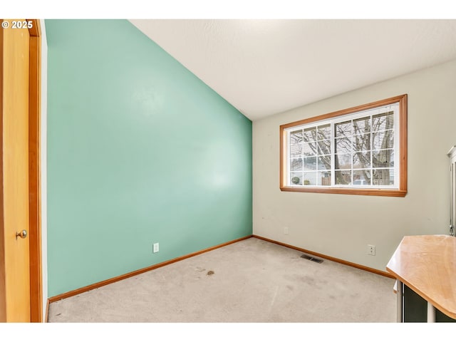 empty room featuring baseboards, carpet, and visible vents