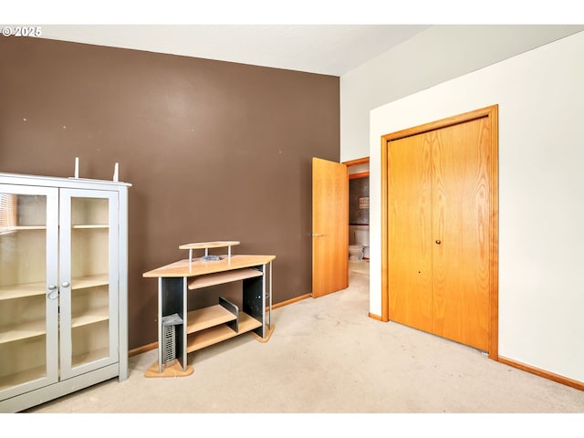 interior space featuring baseboards and carpet