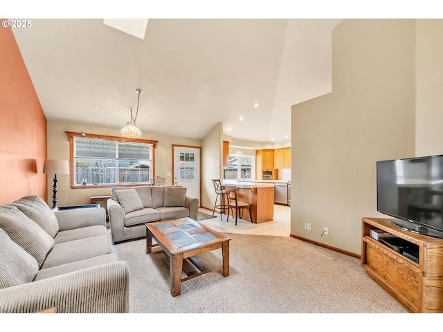 living area with baseboards, light carpet, and recessed lighting