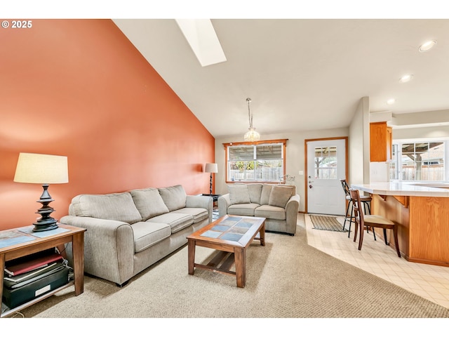 living room featuring recessed lighting, lofted ceiling with skylight, and a wealth of natural light