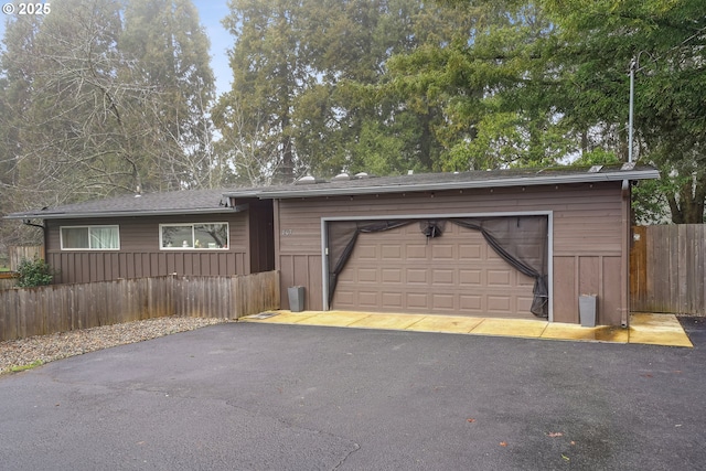 view of front facade with an attached garage and fence