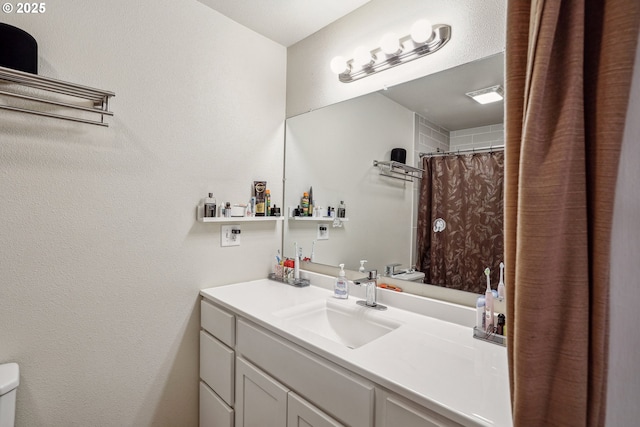 full bath featuring vanity and toilet