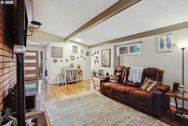 living area with vaulted ceiling with beams, baseboards, and wood finished floors