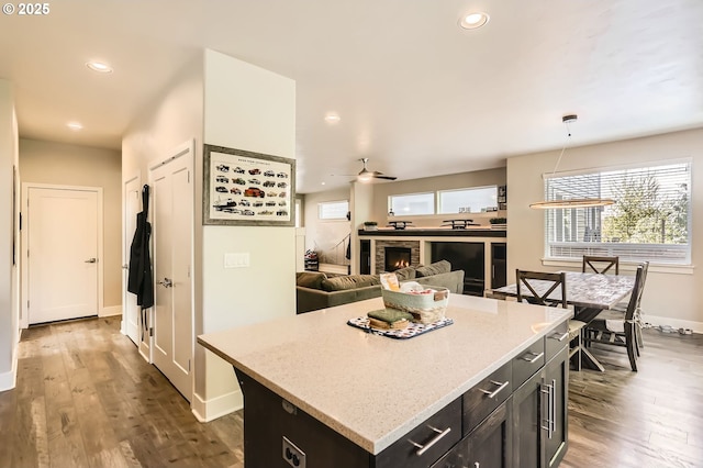 kitchen with plenty of natural light, ceiling fan, baseboards, dark wood-style floors, and recessed lighting
