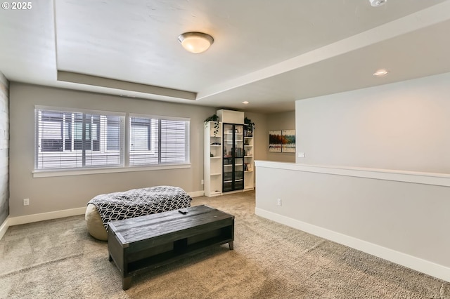 sitting room featuring recessed lighting, carpet floors, a tray ceiling, and baseboards