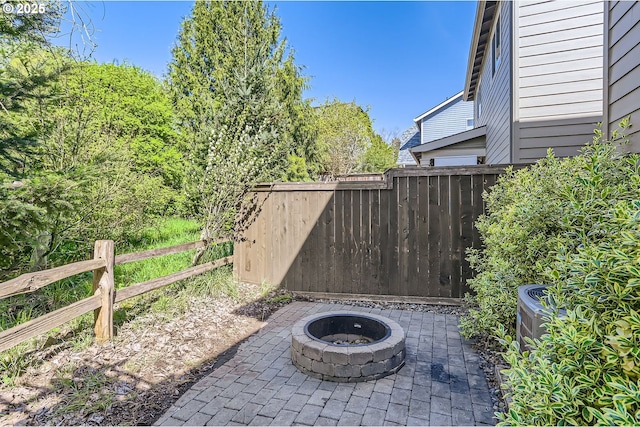 view of patio / terrace featuring fence and an outdoor fire pit