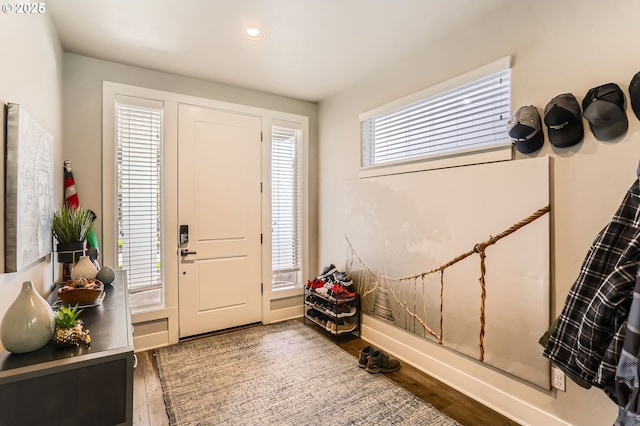 entryway with baseboards, wood finished floors, and recessed lighting