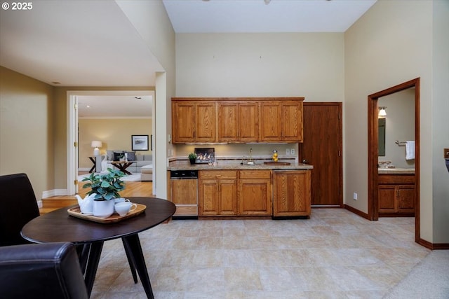 2350 SW Gregory Dr, West Linn, OR 97068 - kitchen with brown cabinetry, light stone counters, and a towering ceiling