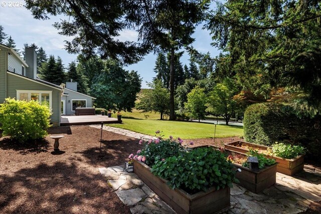 2350 SW Gregory Dr, West Linn, OR 97068 - view of grassy yard with a vegetable garden and a deck