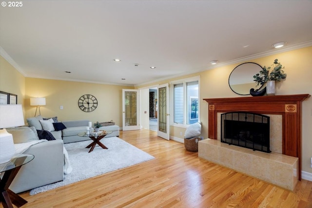 2350 SW Gregory Dr, West Linn, OR 97068 - living room featuring light wood finished floors, ornamental molding, a tiled fireplace, and recessed lighting