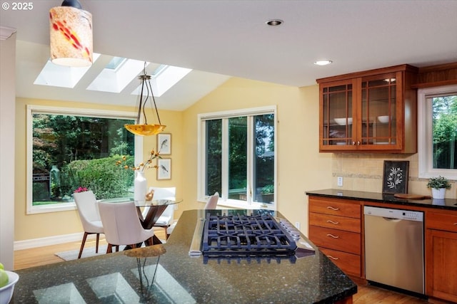 2350 SW Gregory Dr, West Linn, OR 97068 - kitchen with stainless steel dishwasher, gas cooktop, a skylight, glass insert cabinets, and tasteful backsplash