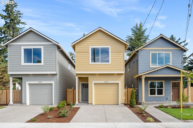 view of front facade featuring fence, driveway, and an attached garage