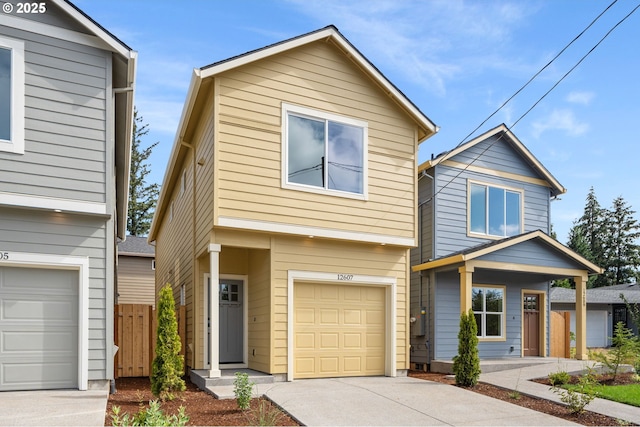 view of front of home featuring a garage, driveway, and fence