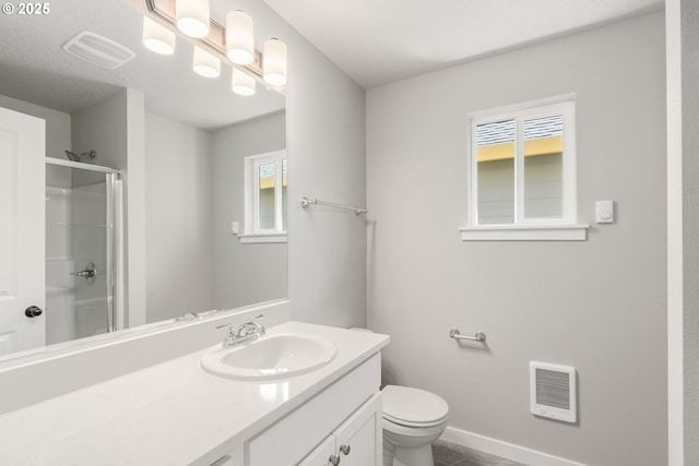 full bathroom with baseboards, visible vents, toilet, a shower with door, and vanity