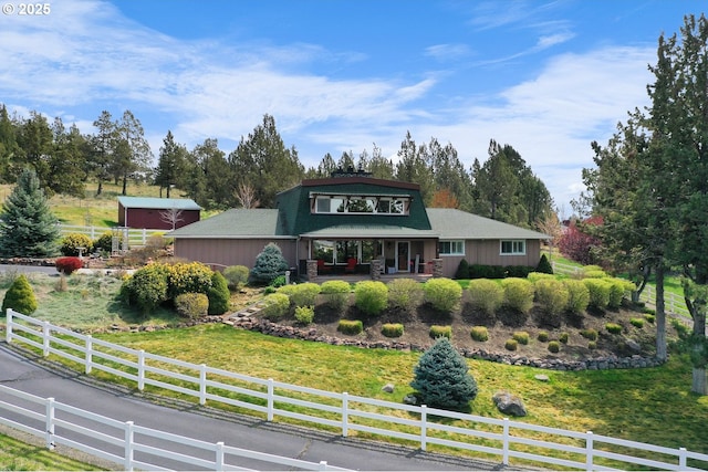 view of front of property with a front lawn and fence