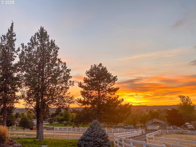 yard at dusk featuring fence
