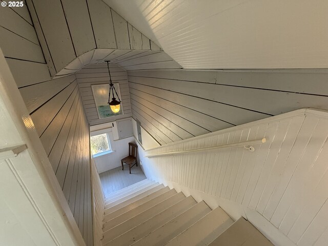 stairs featuring a wainscoted wall