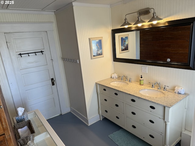 full bathroom with a sink, baseboards, and double vanity