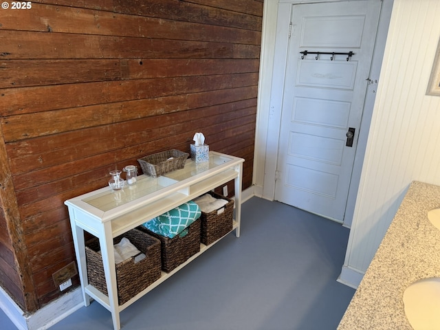 mudroom featuring wooden walls