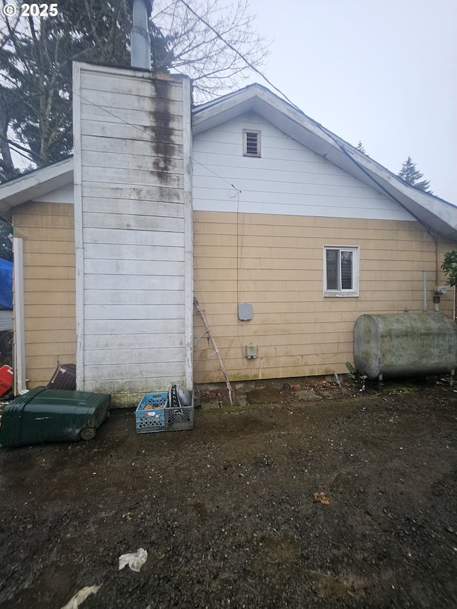 view of side of property with heating fuel