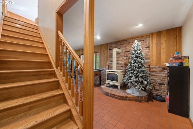62436 Mink Ln, Summerville, OR 97876 - staircase with a wood stove, tile patterned floors, and wooden walls