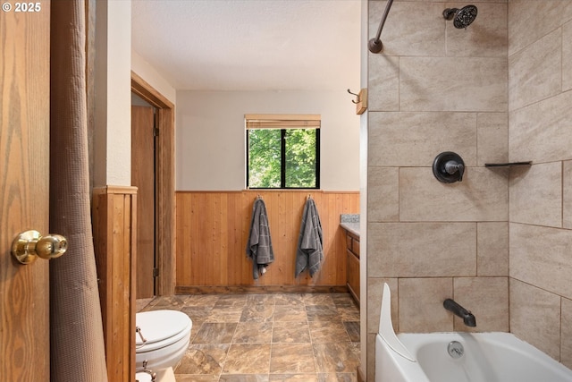 62436 Mink Ln, Summerville, OR 97876 - full bath featuring a wainscoted wall, wood walls, toilet, shower / bathtub combination, and stone finish floors