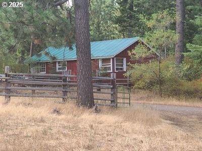 62436 Mink Ln, Summerville, OR 97876 - view of front facade featuring metal roof and a forest view