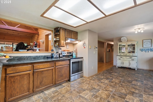 62436 Mink Ln, Summerville, OR 97876 - kitchen featuring stainless steel electric range, brown cabinetry, dark countertops, open shelves, and wooden walls