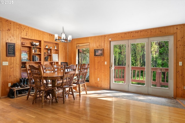 62436 Mink Ln, Summerville, OR 97876 - dining room featuring wood walls, a chandelier, and wood finished floors