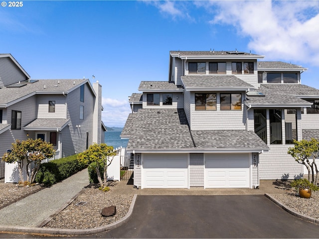 765 5th Ave Unit 5, Hammond, OR 97121 - view of front of house with asphalt driveway, an attached garage, a shingled roof, and solar panels