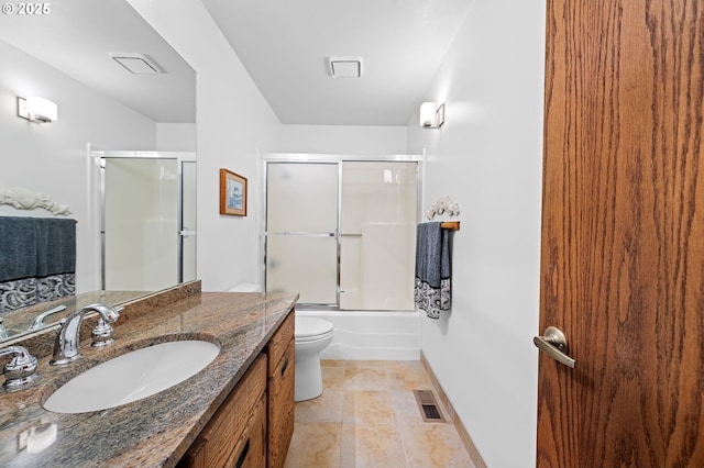 765 5th Ave Unit 5, Hammond, OR 97121 - bathroom featuring vanity, toilet, bath / shower combo with glass door, and baseboards
