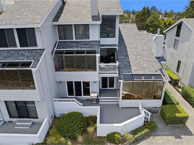 765 5th Ave Unit 5, Hammond, OR 97121 - rear view of property with a shingled roof, a chimney, and a sunroom