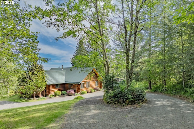 35919 NE 25th Cir, Washougal, WA 98671 - cabin with log exterior, dirt driveway, and metal roof
