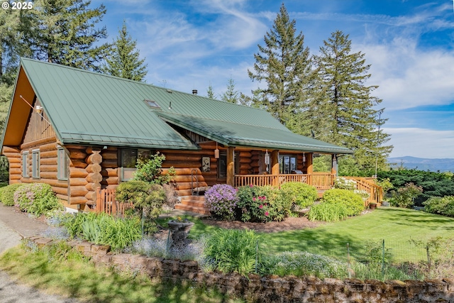 35919 NE 25th Cir, Washougal, WA 98671 - cabin with log exterior, covered porch, a front yard, a standing seam roof, and metal roof