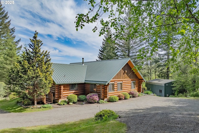 35919 NE 25th Cir, Washougal, WA 98671 - view of front of house with log exterior, dirt driveway, and metal roof