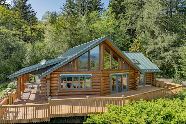 35919 NE 25th Cir, Washougal, WA 98671 - rear view of house with log exterior, a deck, metal roof, and a view of trees