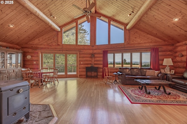 35919 NE 25th Cir, Washougal, WA 98671 - living room with high vaulted ceiling, wood ceiling with exposed beams, ceiling fan, rustic walls, and a wood stove
