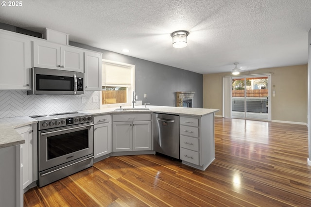 kitchen with white cabinetry, stainless steel appliances, dark hardwood / wood-style flooring, and sink