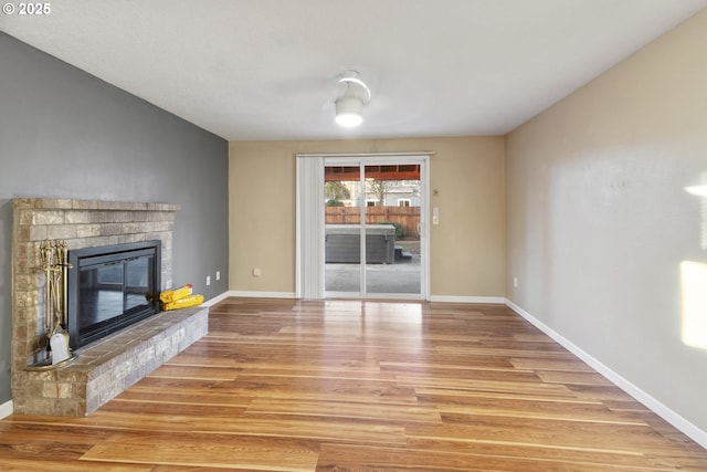 unfurnished living room featuring hardwood / wood-style floors and a fireplace