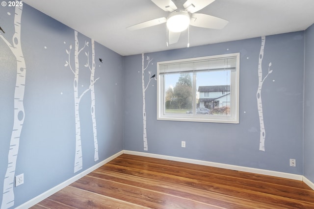 spare room featuring wood-type flooring and ceiling fan